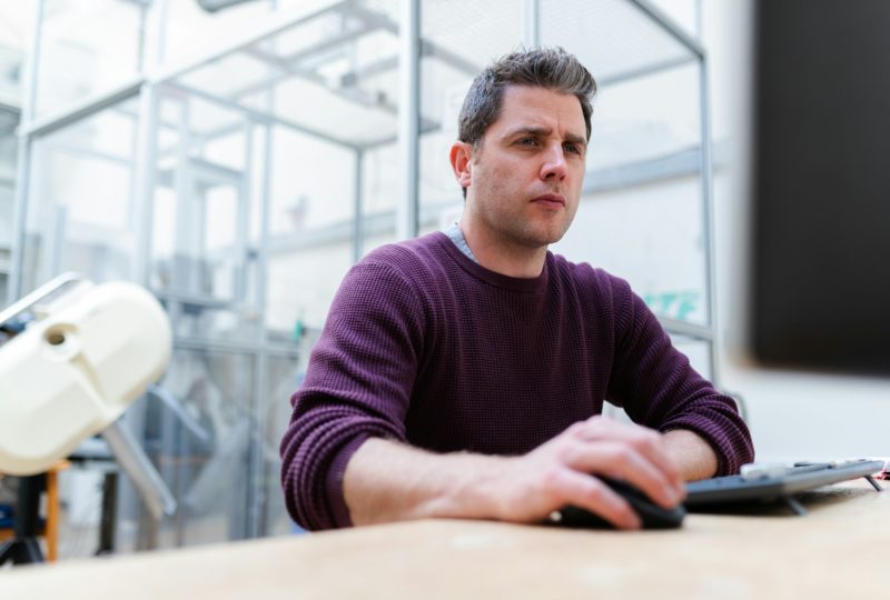 Man on computer at desk, Integrated solutions and ancillaries | High Dream